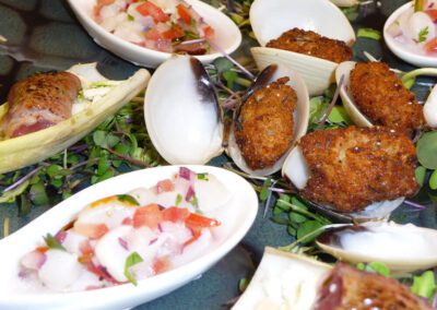 Sampler of chicken wings and ceviche appetizers.