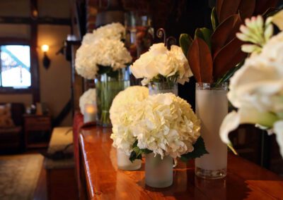 White flowers in a vase on a dresser