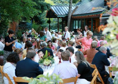 Outdoor wedding, guest eating at outdoor tables.