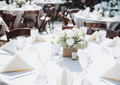 White table cloth with floral center piece.